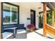 Inviting front porch featuring seating, a black door, and stylish accents at 4467 King St, Denver, CO 80211