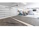 Spacious garage with gym equipment, cabinets, and a wide open area with large epoxy floor panels at 4467 King St, Denver, CO 80211