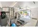 Garage gym with exercise equipment, TV, and cabinets, with glass door view to outdoor patio at 4467 King St, Denver, CO 80211