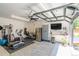 Workout space with elliptical, free weights, weight machine, and pull-up bar in a garage with glass door at 4467 King St, Denver, CO 80211