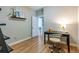 Office space with neutral color scheme, hardwood floors, black modern desk and decorative shelving at 4467 King St, Denver, CO 80211
