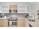 Modern kitchen with stainless steel appliances and wood cabinets at 1818 S Quebec Way # 11-8, Denver, CO 80231