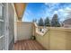 Small deck patio with surrounding trees at 1818 S Quebec Way # 11-8, Denver, CO 80231