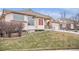 Beige two-story home with landscaping and a two-car garage at 3275 S Indiana St, Lakewood, CO 80228