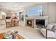 Living room features a fireplace, built-in shelving, and large windows at 3275 S Indiana St, Lakewood, CO 80228