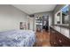 A bright bedroom with a large closet, hardwood floors, and ample storage space at 747 Mockingbird St, Brighton, CO 80601