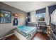 This bedroom is decorated with sports decor, complemented by hardwood floors and natural light at 747 Mockingbird St, Brighton, CO 80601