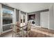 A dining room area with natural light, a wooden table, and a washer and dryer combo at 747 Mockingbird St, Brighton, CO 80601