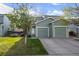 A charming two-story home with a well-maintained lawn, white door, and attached two-car garage at 747 Mockingbird St, Brighton, CO 80601