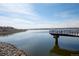Picturesque lake view with calm waters and a lakeside pier at 747 Mockingbird St, Brighton, CO 80601