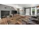 A cozy living room with hardwood floors, gray walls, modern decor, and natural light from the front door at 747 Mockingbird St, Brighton, CO 80601