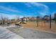Community playground with slides, climbing structures, and a swing set amidst a residential area at 747 Mockingbird St, Brighton, CO 80601