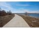 Scenic walking path near a lake, perfect for outdoor activities and enjoying nature at 747 Mockingbird St, Brighton, CO 80601