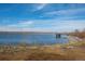 Beautiful view of the lake with a pier and natural landscape, offering a serene and picturesque environment at 747 Mockingbird St, Brighton, CO 80601