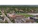 Aerial view of a sports complex with a multi-story building, football field, and a parking lot in a tree-lined suburban neighborhood at 1414 W Nevada Pl, Denver, CO 80223