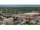 Aerial view features a sports complex with a multi-story building, football field, and a parking lot surrounded by a suburban neighborhood at 1414 W Nevada Pl, Denver, CO 80223