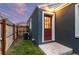 Backyard with green grass, an air conditioning unit, and a wooden fence at 1414 W Nevada Pl, Denver, CO 80223