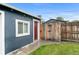 Backyard featuring a walkway, short grass, and a wooden fence at 1414 W Nevada Pl, Denver, CO 80223
