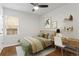 Cozy bedroom with hardwood floors, a comfortable bed, and a functional desk area, perfect for rest and productivity at 1414 W Nevada Pl, Denver, CO 80223