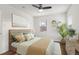 Cozy bedroom with hardwood floors, soft bedding, and a ceiling fan at 1414 W Nevada Pl, Denver, CO 80223