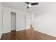 This bedroom features hardwood floors, a ceiling fan, and a closet at 1414 W Nevada Pl, Denver, CO 80223
