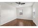 This is an unfurnished bedroom with hardwood floors, two windows, and a ceiling fan at 1414 W Nevada Pl, Denver, CO 80223