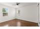 This bright bedroom has hardwood floors, a ceiling fan, and two windows at 1414 W Nevada Pl, Denver, CO 80223