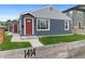 Updated single story home with a red front door, new exterior paint, and a well-kept lawn at 1414 W Nevada Pl, Denver, CO 80223