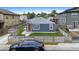 Beautifully updated home featuring a well-kept lawn, new exterior paint, and fenced yard at 1414 W Nevada Pl, Denver, CO 80223