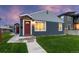 Cozy single-story home featuring blue siding, a red front door, and a well-maintained lawn for a welcoming appearance at 1414 W Nevada Pl, Denver, CO 80223