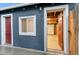 Exterior view of a house with a doorway leading to the garage and a window at 1414 W Nevada Pl, Denver, CO 80223