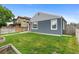 Charming home featuring a well-maintained lawn, garden beds, and inviting red door, perfect for outdoor enjoyment at 1414 W Nevada Pl, Denver, CO 80223