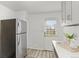 Clean kitchen with stainless steel refrigerator and white countertops with outside access at 1414 W Nevada Pl, Denver, CO 80223