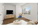 Bright living room featuring hardwood floors, a large window, and stylish modern furniture at 1414 W Nevada Pl, Denver, CO 80223