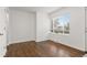 Bright living room with hardwood floors, a large window, and neutral tones offers a serene and relaxing environment at 1414 W Nevada Pl, Denver, CO 80223