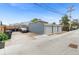 This parking area has a three car garage and a car parked in the driveway at 1414 W Nevada Pl, Denver, CO 80223