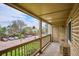 Covered balcony overlooking a parking lot and community greenery at 14700 E Kentucky Dr # 524, Aurora, CO 80012