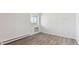 Empty bedroom with light grey vinyl floors, white walls, and a window with natural light at 14700 E Kentucky Dr # 524, Aurora, CO 80012