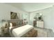 Tastefully staged bedroom with queen bed, plush bedding, area rug and bedside tables at 14700 E Kentucky Dr # 524, Aurora, CO 80012