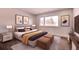 Tastefully staged bedroom with queen bed, plush bedding and light-filled windows at 14700 E Kentucky Dr # 524, Aurora, CO 80012