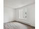 Bright bedroom featuring modern gray laminate flooring and a large window at 14700 E Kentucky Dr # 524, Aurora, CO 80012