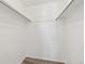 Neutral walk-in closet with a white interior and metal closet rods at 14700 E Kentucky Dr # 524, Aurora, CO 80012