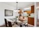 Bright dining room features a glass table, stylish chandelier, and ample natural light at 14700 E Kentucky Dr # 524, Aurora, CO 80012