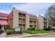 Condominium building with red roof, multiple units, balconies, and well-maintained landscaping at 14700 E Kentucky Dr # 524, Aurora, CO 80012