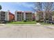 Exterior view of the condominium complex showing lawn and trees at 14700 E Kentucky Dr # 524, Aurora, CO 80012