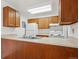 Efficient kitchen with bright countertops, wooden cabinets, and white appliances at 14700 E Kentucky Dr # 524, Aurora, CO 80012