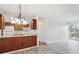 Bright kitchen with white appliances, wood cabinets, and breakfast bar open to the living area at 14700 E Kentucky Dr # 524, Aurora, CO 80012