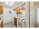 Traditional-style kitchen with white appliances, wood cabinets and neutral countertops at 14700 E Kentucky Dr # 524, Aurora, CO 80012