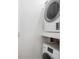 A stacked white washer and dryer provide in-unit laundry convenience at 14700 E Kentucky Dr # 524, Aurora, CO 80012