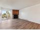 Bright living room with hardwood flooring, fireplace, and balcony access at 14700 E Kentucky Dr # 524, Aurora, CO 80012